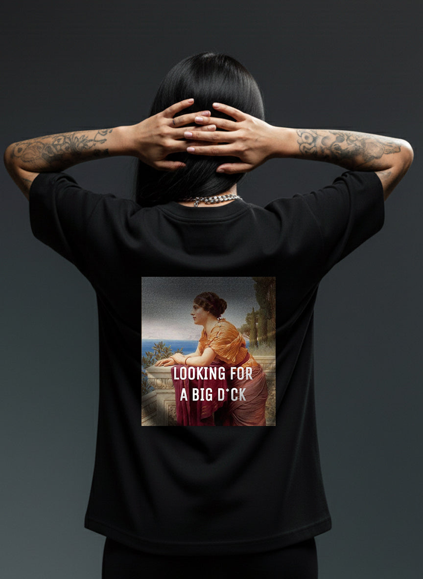 Person wearing a black t-shirt with a graphic design on the back, featuring text and an image of a woman.